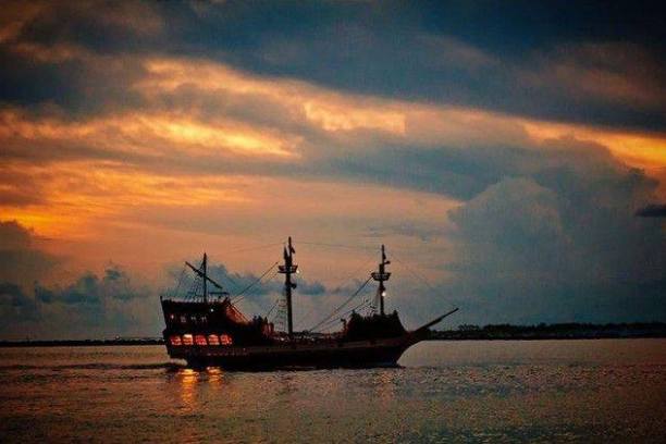 a pirate ship on a night time cruise