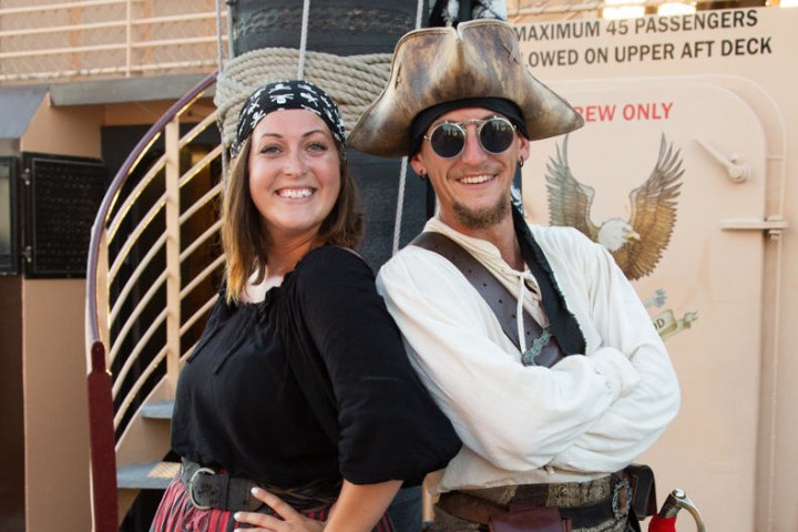 two people dressed as pirates posing for the camera