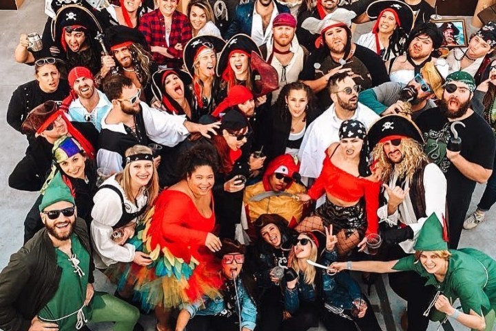 a group of people standing in front of a crowd posing for the camera