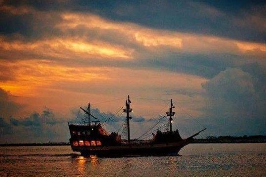 a pirate ship on a night time cruise