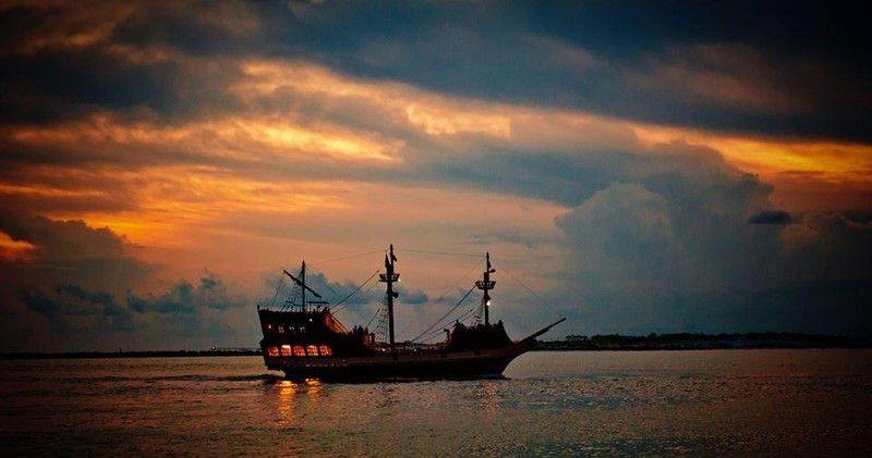 a pirate ship on a night time cruise