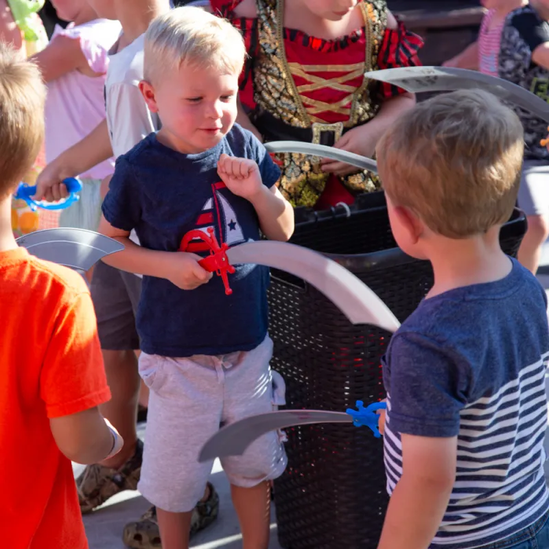 group of kids sword fighting on the deck of the Buccaneer