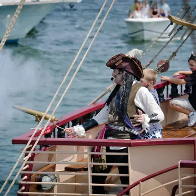 Pirate ship crew member firing the cannon