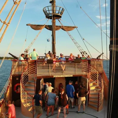 a group of people in a boat on a body of water
