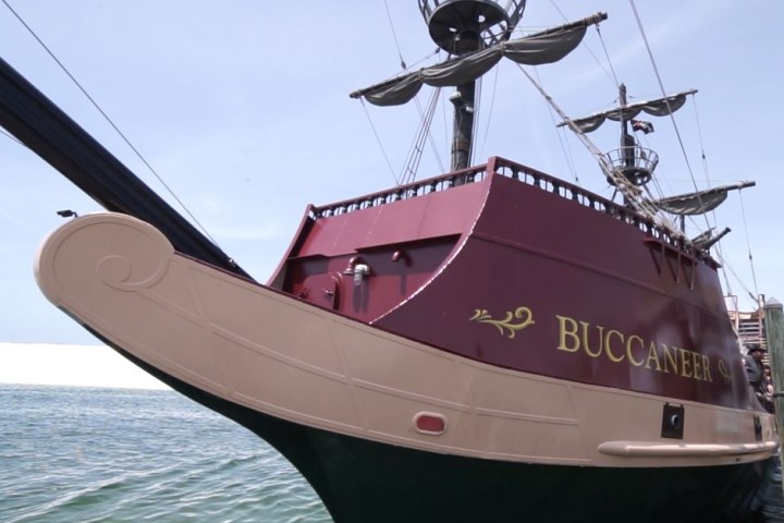 a close up of a boat next to a body of water